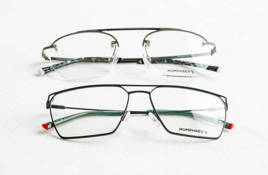 Sophisticated eyeglasses on a smooth white surface, showcasing stylish design.