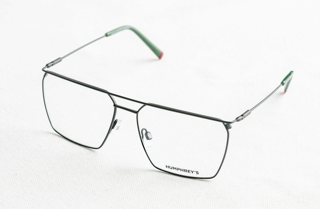 Stylish modern eyeglasses displayed on a white surface, showcasing minimalist design and elegance.