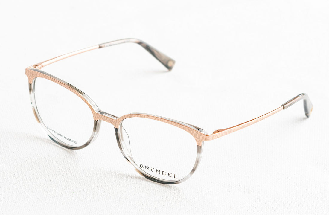 Stylish round eyeglasses with thin metal frame resting on a white surface, perfect for modern fashion and eyewear themes.