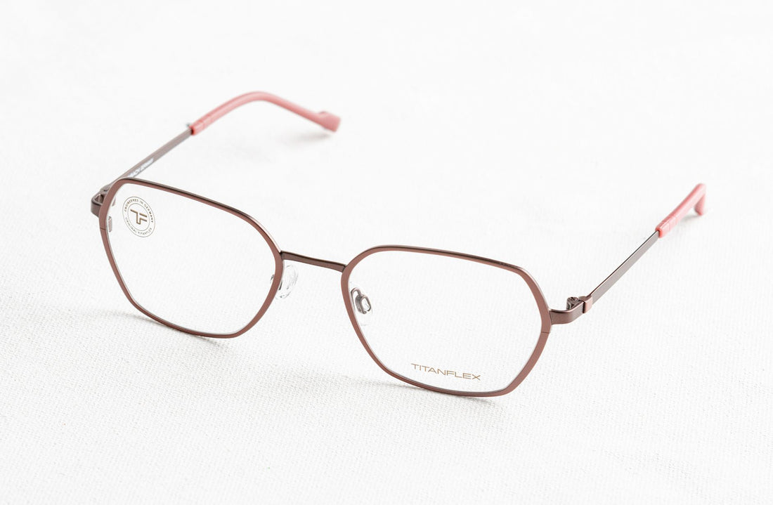 Stylish metal-framed eyeglasses isolated on a white background, ideal for eyewear advertisements.