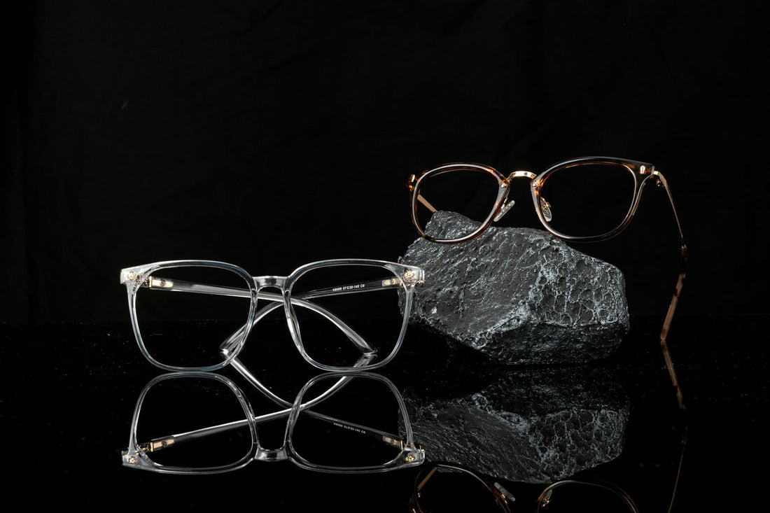 Stylish eyeglasses showcased on a reflective black surface, emphasizing modern fashion and optical design.