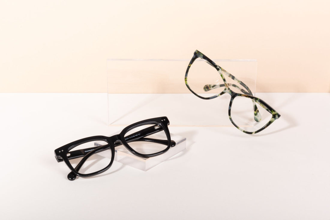 Modern eyeglasses on a minimalist backdrop showcasing black and tortoiseshell frames.