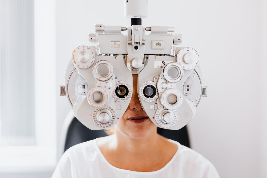 Detailed view of a person undergoing an eye exam with a phoropter in a modern clinic.
