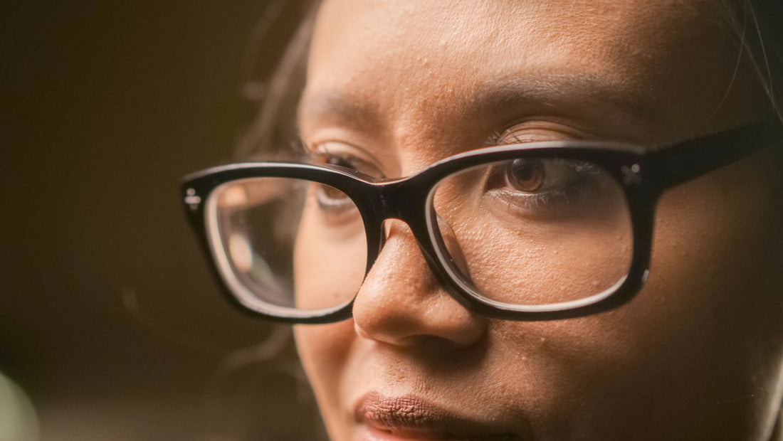 Detailed close-up of a person wearing eyeglasses, showcasing focus and contemplation.