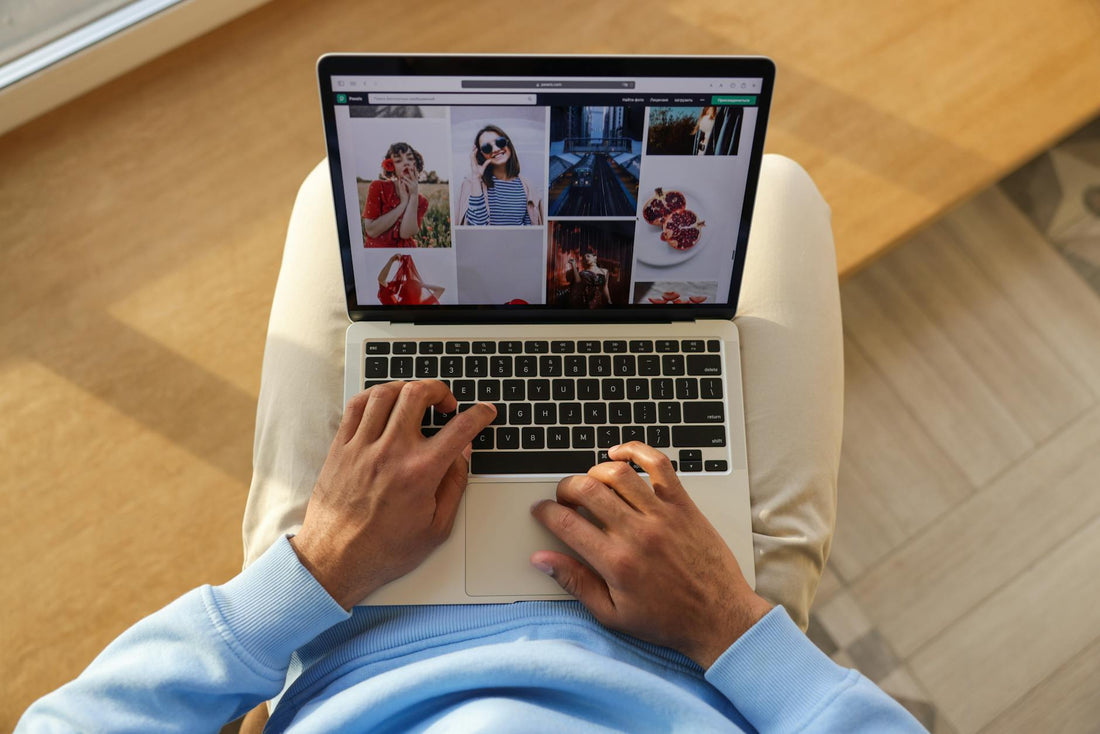 A man casually browsing an online store on a laptop, showing a variety of images.